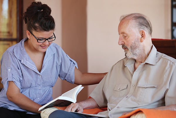 Man with Caregiver Reading Man with Caregiver Reading